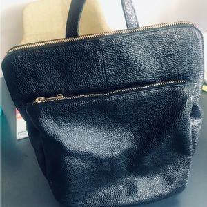 Black leather with gold accents backpack.